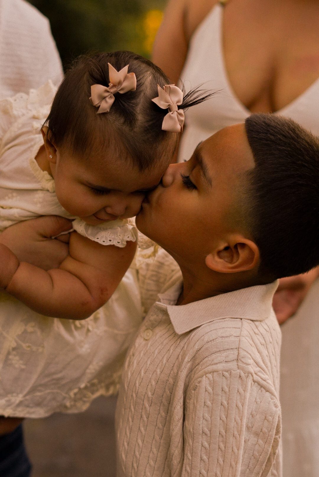 A tender kiss between siblings