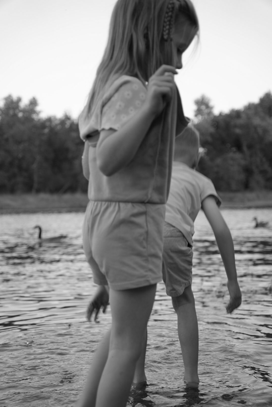 Black-and-white candid moment by the lake