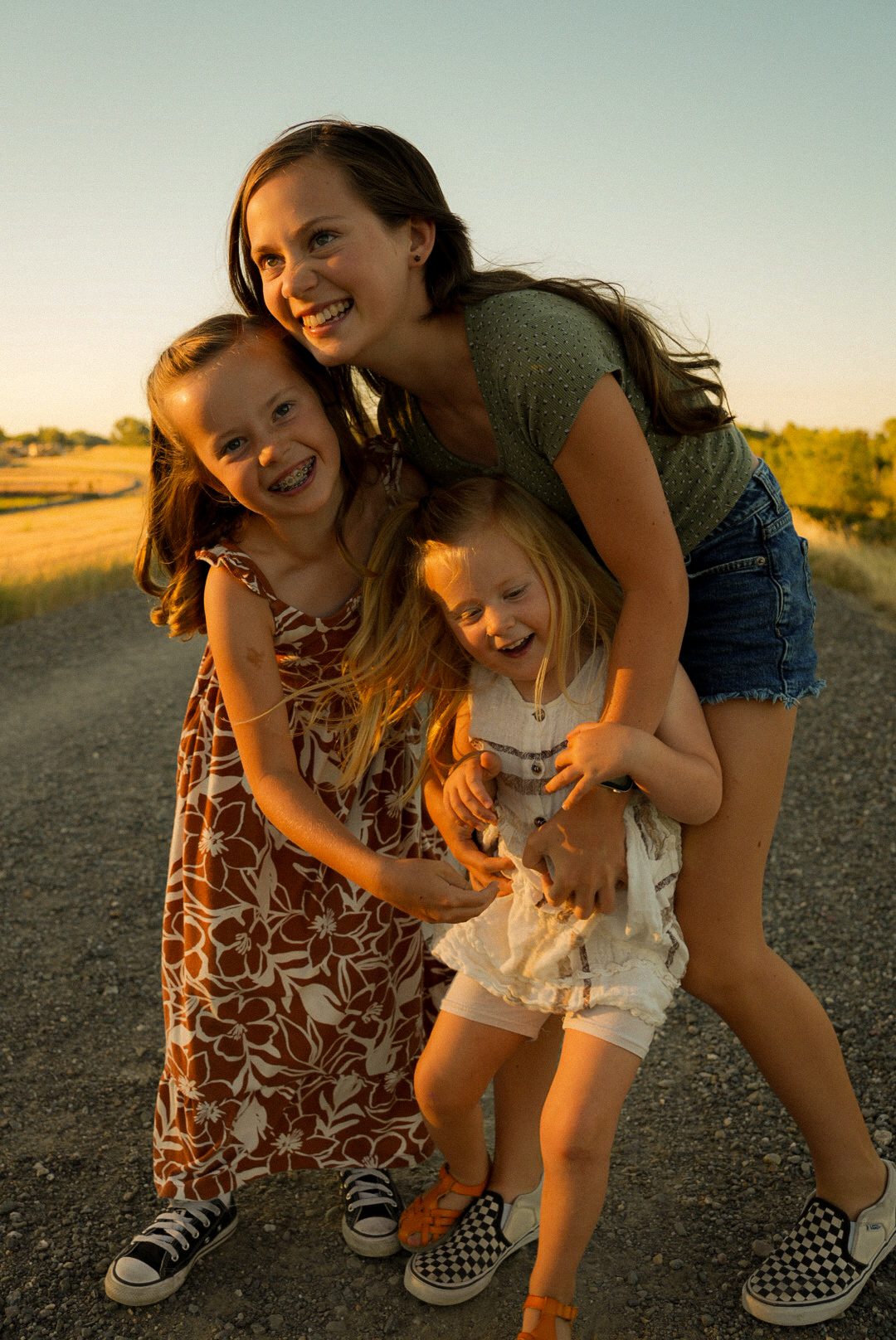 Mom and kids laughing together outdoors