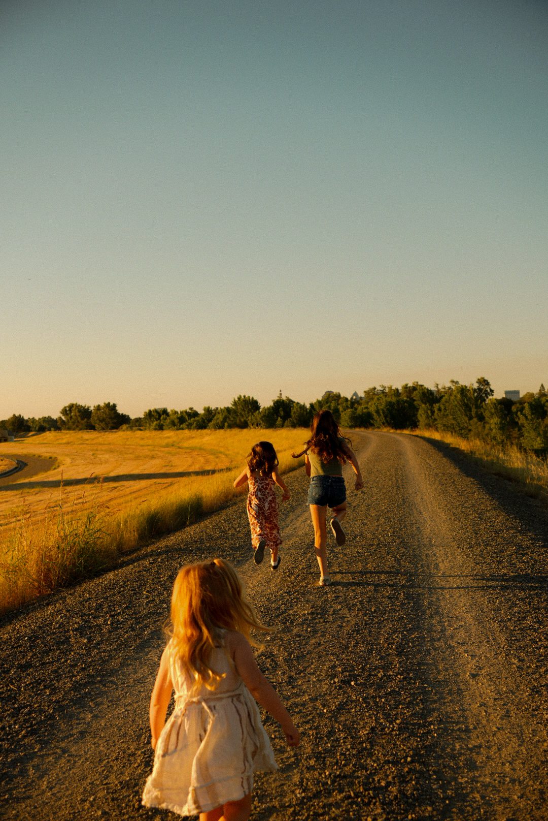 Kids running together on a country road